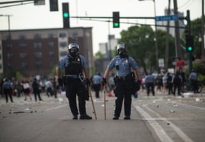 Police officers stand outside the Third Police Precinct during the I Can’t Breathe protest in Minneapolis.